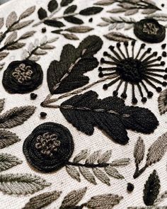 black and white embroidered fabric with leaves on it