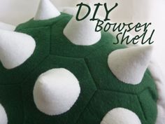 a green and white stuffed animal with spikes on it's head that says diy bouncy shell