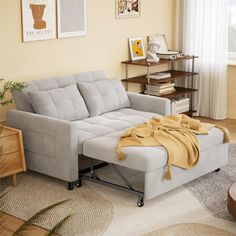 a living room with a couch, coffee table and pictures on the wall