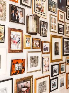 a wall full of pictures and framed photos