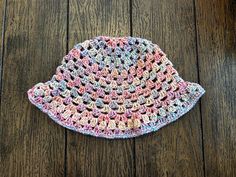 a crocheted hat sitting on top of a wooden floor