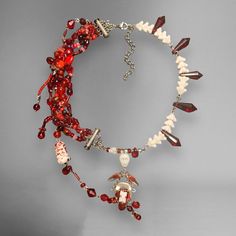 ~40 cm. made w/ glass, preciosa czech crystals, red plated brass, mother of pearl shell, acrylic, thread, stainless steel. not sure what the metal tube clasps are made of. note: freehanded the bloody bead weaving, and there is string showing in a few areas. personally, i think it adds to the handmade charm & fits the theme priced according to time spent (~18 hours), quality of materials, execution and intricacy of concept. 1 of 1. if you are international, feel free to message & i can change the shipping on this listing Solar System Bracelet, Crystals Red, Shiny Jewelry, Goth Necklace, Handmade Chokers, Choker Jewelry, Skull Necklace, Funky Jewelry, Czech Crystal