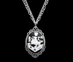 a necklace with a white and black crest on it