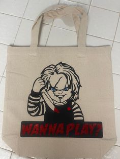 a tote bag with an image of a clown holding a knife and the words wanna play on it