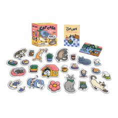 an assortment of stickers and magnets in front of a box with the words cat cafe on it