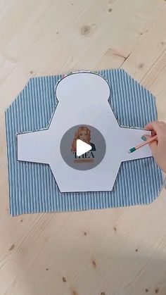 someone is holding a toothbrush and cutting out a paper cutout with the image of a dog on it