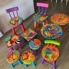 colorful wooden chairs and stools on the floor