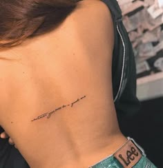 a woman's lower back tattoo with the words, love and life written on it