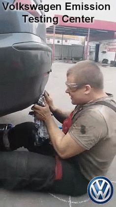 a man working on the side of a car