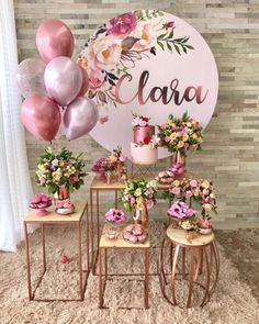 a table topped with lots of pink and yellow flowers next to a sign that says ciara