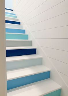 blue and white painted stairs leading up to the top floor in a house or office