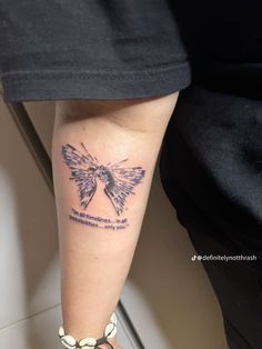 a woman's leg with a butterfly tattoo on her left arm and the words,