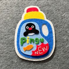 a blue and yellow plastic bottle with a penguin on it's side that says, pingy new