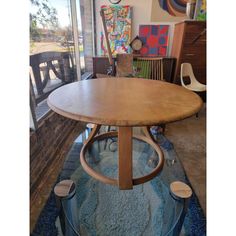 a wooden table sitting on top of a blue rug