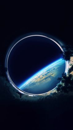 an image of the earth seen through a hole in the sky with clouds around it