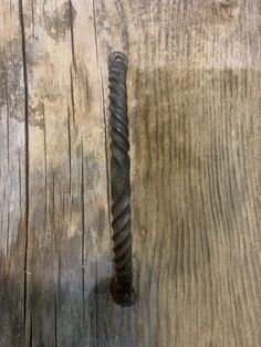 an old metal object sitting on top of a wooden table