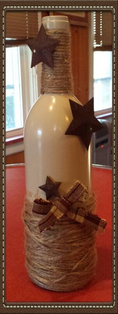 a bottle decorated with twine and stars