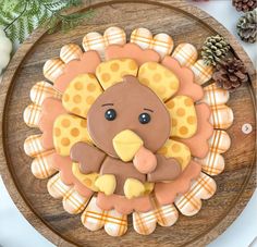 a decorated turkey cookie sitting on top of a wooden plate