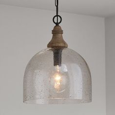 The mixed-material look of this 1-light single pendant is the perfect blend of coastal and farmhouse styles in your space. It's made from a blend of metal and wood with dark pewter and brown finish for two-toned color contrast. The rounded canopy easily mounts to ceilings - even sloped ceilings! - and the chain is adjustable to suit the size of your kitchen, entryway, or dining room. Its 15" wide dome-shaped shade comes in your choice of glass, and it disperses light from a single bulb up to 100 Dark Pewter, Pewter Pendant, Kitchen Entryway, Pendant Ceiling Light, Hudson Valley Lighting