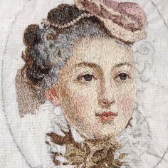 an embroidered portrait of a woman with a hat on her head and hair pulled back