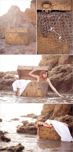 a woman laying on top of a wooden box in the water next to some rocks