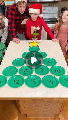 a group of kids standing around a table with numbers on it