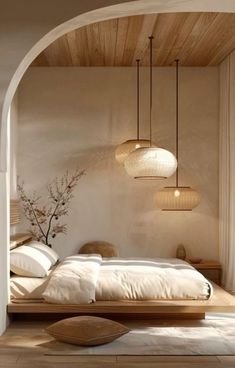 a bed room with a neatly made bed and two lamps hanging from the ceiling above it