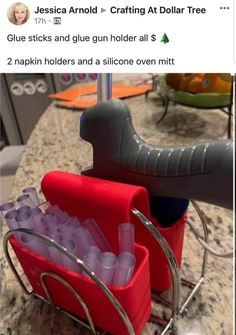 a red basket filled with plastic cups on top of a counter next to a metal rack