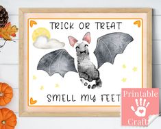 a halloween sign with a bat on it and handprinted pumpkins in the background