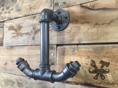 a metal pipe mounted to the side of a wooden wall