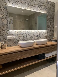 a bathroom with two sinks and a large mirror