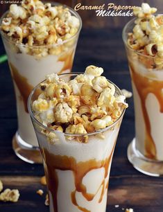 two glasses filled with food sitting on top of a table