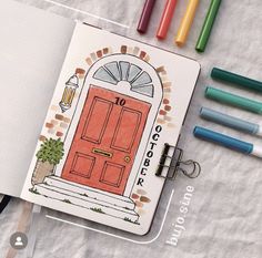 an open notebook with colored markers next to it