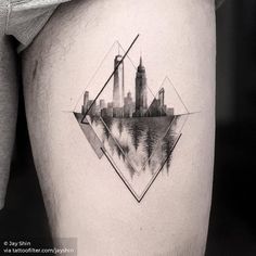 a city skyline tattoo on the thigh