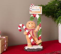 a gingerbread man holding a candy cane