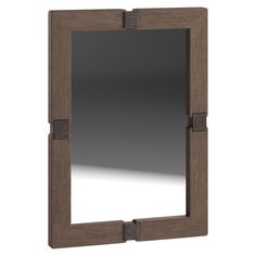 a wooden frame mirror sitting on top of a white wall