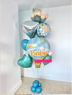 a bunch of balloons that are in the shape of a baby's first birthday