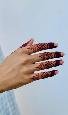 a woman's hand with hendix on it and her fingers painted red