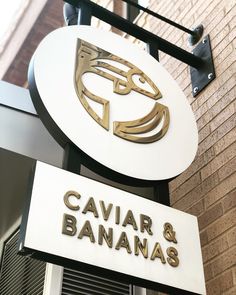 the sign for caviar and bananaas is hanging from the side of a building