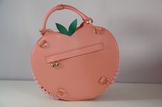 I'm so happy to share my original Frilly Fruits collection! This bag is inspired by the peach fruit, and is my second ever design. This stunning monochrome peach bag comes with removable "leaves" and is the perfect accessory for any occasion. Subtle enough for daily wear, yet fancy enough to pair with your favourite lolita or kitschy coords ♡ DETAILS + FEATURES : ♡ Dimensions: 30cm(H)X31cm(W)X12cm(D)♡ Comes with 2 adjustable straps: Up to 129.5cm (not including buckle and lobster length) primari Cute Orange Everyday Bag, Cute Orange Everyday Bags, Candy Themed Bedroom, Peach Items, Kawaii Bag, Peach Fruit, Unique Handbags, Themed Bedroom, Cute Patches