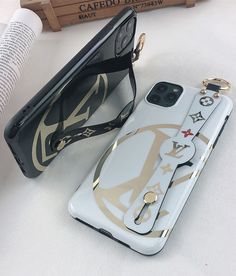 the phone case is decorated with gold and white designs, along with a pair of sunglasses