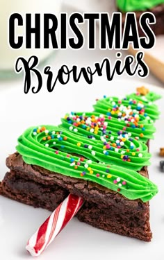 christmas brownies with green frosting and sprinkles on a white plate