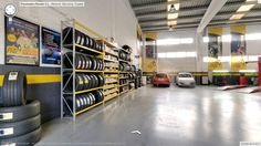 the inside of a car repair shop filled with tires