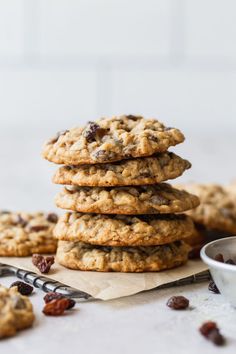 chocolate chip cookies stacked on top of each other with raisins around the edges