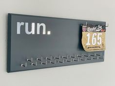 a sign that says run hangs on the wall