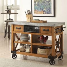 a kitchen island with wheels and baskets on it