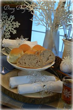 a plate with some bread on it and napkins next to the plate are snowflakes