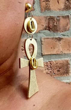 These are unqiue and fabulous Perfect size  Handmade original design  They are very lightweight  Ankh symbol with blingy gold accents  They hang 4 inches long  These are one of a kind  Sturdy  Clip on closure These are a very unique addition to any wardrobe African Earrings Handmade, Crystal Wraps, African Ceramics, Ankh Earrings, Wooden Bracelets, Diy Tassel Earrings, Ankh Symbol, African Earrings, Wooden Bracelet