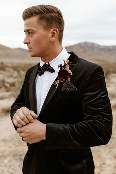 a young man in a tuxedo and bow tie looking off into the distance