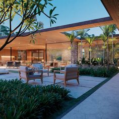 an outdoor living area with chairs and tables